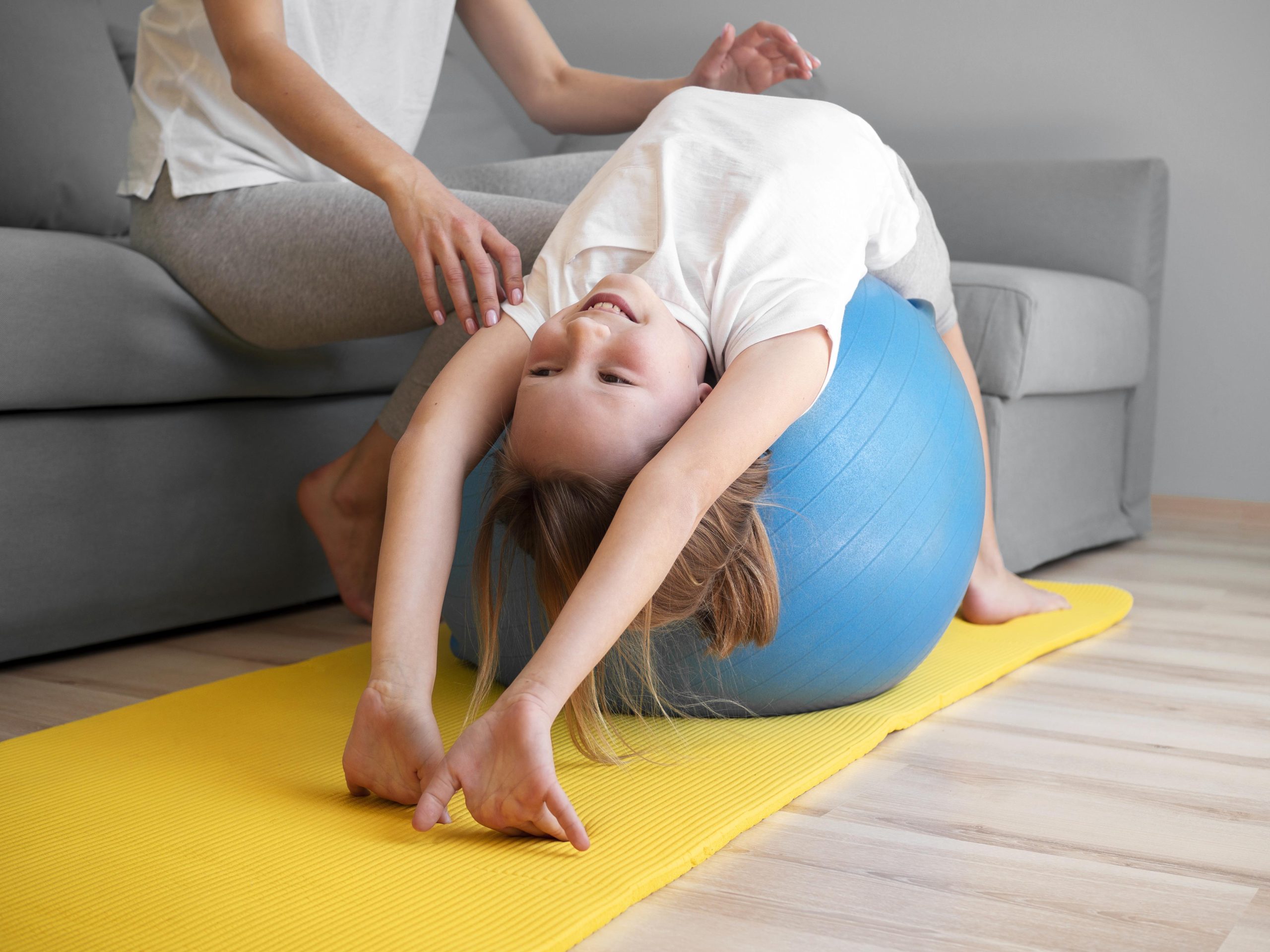 https://cmdenfant.com/wp-content/uploads/2026/04/mother-helping-girl-exercise-ball-scaled.jpg